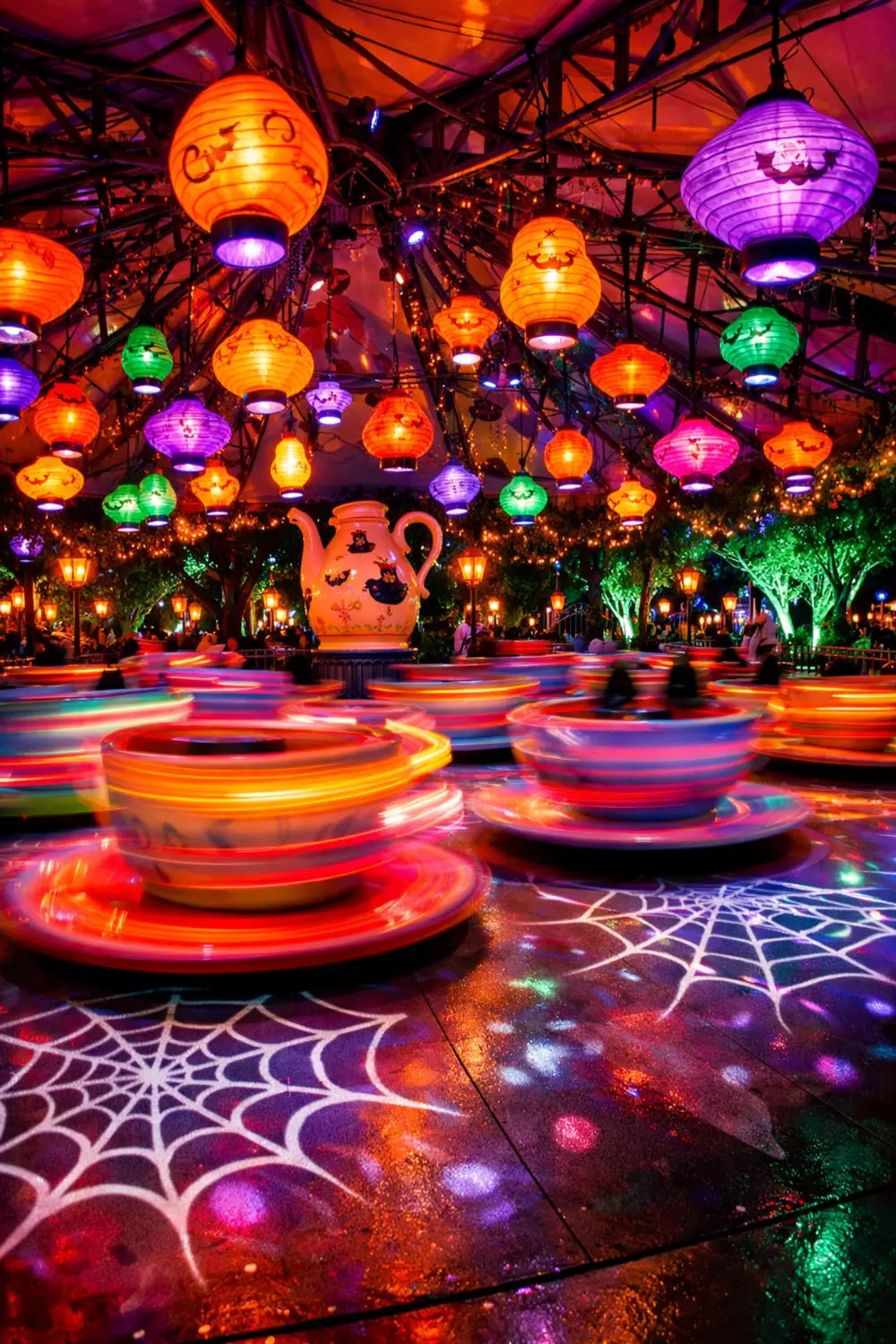 The Mad Tea Party ride at Magic Kingdom featuring a spooky Halloween lighting overlay.